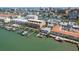 Beautiful aerial view of waterfront condos with private docks, boats, and mature landscaping at 120 Brightwater Dr, Clearwater Beach, FL 33767