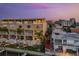 Stunning waterfront condo with balconies, pools, and city views at dusk at 120 Brightwater Dr, Clearwater Beach, FL 33767
