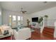 Living room with waterfront views, hardwood floors, and staircase leading to the upper level at 120 Brightwater Dr, Clearwater Beach, FL 33767