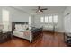 Spacious main bedroom featuring a ceiling fan, large window, and hardwood floors at 120 Brightwater Dr, Clearwater Beach, FL 33767