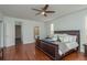 Spacious main bedroom featuring access to a bathroom, ceiling fan, and hardwood floors at 120 Brightwater Dr, Clearwater Beach, FL 33767