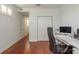 Functional office space featuring hardwood floors and ample storage with a bright window and natural light at 120 Brightwater Dr, Clearwater Beach, FL 33767