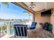 Comfortable patio with blue cushioned seating, grill, and waterfront view at 120 Brightwater Dr, Clearwater Beach, FL 33767