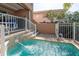 Inviting pool featuring a serene spillover and stone accents, perfect for relaxation at 120 Brightwater Dr, Clearwater Beach, FL 33767