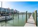 Picturesque waterfront view with a private boat dock and a sailboat on the water at 120 Brightwater Dr, Clearwater Beach, FL 33767