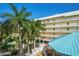Aerial view of a multi-story building surrounded by lush landscaping and a pool area at 12000 Gulf Blvd # 403-S, Treasure Island, FL 33706