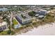 Stunning aerial view of beachfront condo complex, pool, and sandy beach at 12000 Gulf Blvd # 403-S, Treasure Island, FL 33706