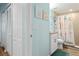 The bathroom has wood-look flooring, a starfish-themed shower curtain, a granite countertop, and white cabinets at 12000 Gulf Blvd # 403-S, Treasure Island, FL 33706