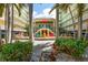 Charming courtyard with colorful Adirondack chairs, tropical foliage, and a relaxing atmosphere at 12000 Gulf Blvd # 403-S, Treasure Island, FL 33706