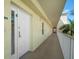 Long hallway with a security door and a stunning view of palm trees and blue skies at 12000 Gulf Blvd # 403-S, Treasure Island, FL 33706