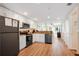 Modern kitchen with white cabinetry, granite countertops, and stainless steel appliances overlooking the living area at 12000 Gulf Blvd # 403-S, Treasure Island, FL 33706
