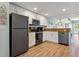 Well-lit kitchen with new stainless steel appliances and white cabinets overlooking the living room at 12000 Gulf Blvd # 403-S, Treasure Island, FL 33706