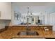 Stylish kitchen sink with granite countertops and a view to the living space beyond at 12000 Gulf Blvd # 403-S, Treasure Island, FL 33706
