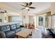 Comfortable living room features an ocean view, a ceiling fan, sliding door to a balcony, and modern furnishings at 12000 Gulf Blvd # 403-S, Treasure Island, FL 33706
