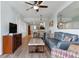 Bright living room with an open concept, offering a dining area, a comfortable sofa, and a TV at 12000 Gulf Blvd # 403-S, Treasure Island, FL 33706