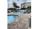 Large community pool with plenty of people enjoying swimming and sunbathing at 12000 Gulf Blvd # 403-S, Treasure Island, FL 33706