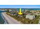 Stunning aerial view of beachfront property with lush greenery and sparkling ocean views at 12458 1St W St, Treasure Island, FL 33706