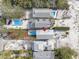 Aerial view of multiple houses with pools on a sandy lot at 12458 1St W St, Treasure Island, FL 33706