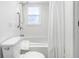 Bright bathroom featuring a tub, shower, and white tiled walls at 12458 1St W St, Treasure Island, FL 33706