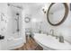 Bright bathroom with tub, vintage fixtures, and charming nautical accents at 12458 1St W St, Treasure Island, FL 33706
