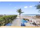 Breathtaking beach view featuring a private sandy area with picnic table, hammock, and grill at 12458 1St W St, Treasure Island, FL 33706