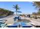 Beach area features chairs, picnic table, palm trees, a grill, and outdoor games at 12458 1St W St, Treasure Island, FL 33706