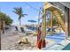 Beautiful beach area with chairs, picnic table, hammock and palm trees for a relaxing vacation at 12458 1St W St, Treasure Island, FL 33706