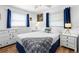 A coastal bedroom with white furniture, nautical decor, and natural light from two windows at 12458 1St W St, Treasure Island, FL 33706