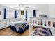 This bedroom features a bed, bunkbeds, white furniture and nautical themed decor at 12458 1St W St, Treasure Island, FL 33706