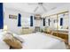 Bedroom with mirrored closet doors, a mounted TV, and cream-colored furniture at 12458 1St W St, Treasure Island, FL 33706