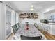 Dining area with seating for six and sliding doors leading to outdoor deck at 12458 1St W St, Treasure Island, FL 33706