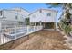 Exterior home view with underneath patio area and a pool in a fenced yard at 12458 1St W St, Treasure Island, FL 33706
