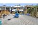 Beach house exterior featuring an outdoor seating area, hammock, picnic table, and beach games at 12458 1St W St, Treasure Island, FL 33706