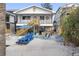 Charming beach house with a beachside backyard, complete with a picnic table, hammock, and outdoor seating at 12458 1St W St, Treasure Island, FL 33706