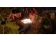 People gather around a lively fire pit, seated in chairs, as they enjoy each other's company at 12458 1St W St, Treasure Island, FL 33706