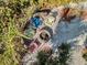 Overhead shot of an outdoor seating area with a fire pit and four chairs surrounded by lush plants at 12458 1St W St, Treasure Island, FL 33706