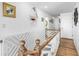 Hallway boasts beautiful wood railings, laminate floors, and nautical décor at 12458 1St W St, Treasure Island, FL 33706