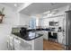Bright kitchen features stainless appliances, sleek black counters, and white cabinetry at 12458 1St W St, Treasure Island, FL 33706