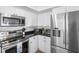 Stainless appliances and white cabinets provide a modern feel to this sleek kitchen at 12458 1St W St, Treasure Island, FL 33706