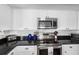 Charming kitchen has stainless appliances, white subway tile, and modern fixtures at 12458 1St W St, Treasure Island, FL 33706