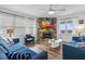Bright living room features a stone fireplace, hardwood floors, and ocean views at 12458 1St W St, Treasure Island, FL 33706