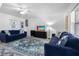 Comfortable living room with two blue sofas, accent rug, and entertainment setup at 12458 1St W St, Treasure Island, FL 33706