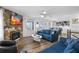 Cozy living room includes a stone fireplace, hardwood floors, and open dining area at 12458 1St W St, Treasure Island, FL 33706