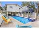 Inviting backyard featuring a private pool, hot tub, and comfortable seating at 12458 1St W St, Treasure Island, FL 33706