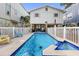 Private pool and hot tub area surrounded by a white picket fence for relaxing outdoor enjoyment at 12458 1St W St, Treasure Island, FL 33706