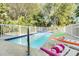 Inviting backyard pool with a spa and lounge chairs for relaxation at 12458 1St W St, Treasure Island, FL 33706