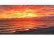 Beautiful sunset over the ocean with fiery orange skies and calm waters at 12458 1St W St, Treasure Island, FL 33706