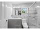 Bright bathroom featuring a gray vanity, modern fixtures, and tiled walk-in shower at 12660 118Th St, Largo, FL 33778