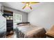 Cozy bedroom with a ceiling fan, a window letting in natural light and dark wood floors at 12660 118Th St, Largo, FL 33778