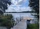 Community dock with a boat ramp to a picturesque lake surrounded by trees at 12660 118Th St, Largo, FL 33778